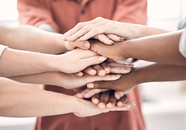 Group of diverse businesspeople piling their hands together in an office at work. Business professionals having fun standing with their hands stacked for support and unity. - Fotoğraf, Görsel