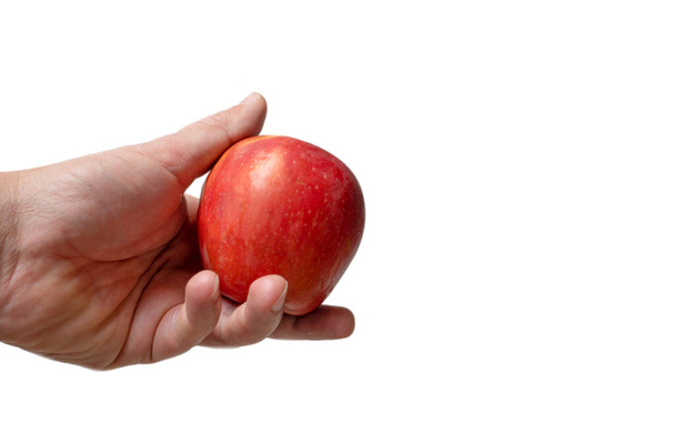 Man hand hold one red apple fruit on isolated  white background - Фото, зображення