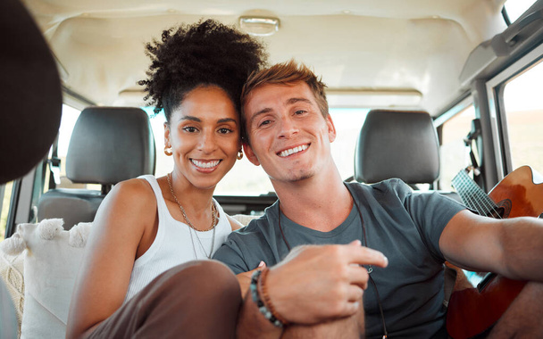 Portrait, diversity couple and in car on holiday being together romantic, bonding and excited for road trip. Love, man and woman travel on vacation, romance break and enjoy loving getaway in vehicle - Fotó, kép