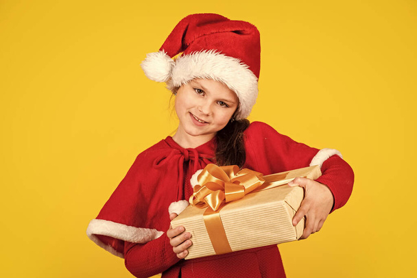 Magic moment. kid with purchase. christmas shopping and sale. xmas party surprise. winter holiday mood. surprise for new year holiday. everyone will get a present. small girl in santa costume. - Fotó, kép