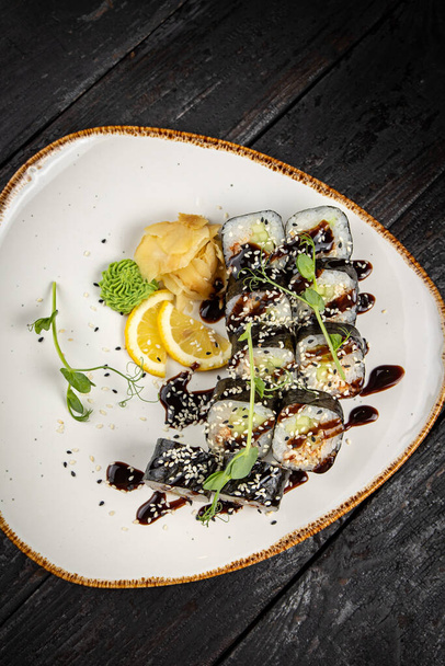 sushi roll with wasabi and sesame seeds on the plate. delicious food, close-up - Φωτογραφία, εικόνα