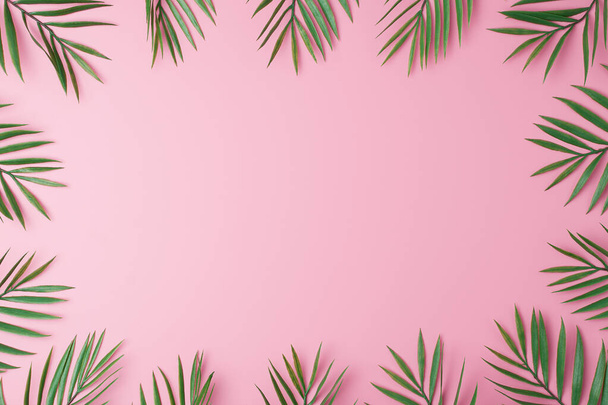 Pink background with palm leaves. Flat lay, copy space - Zdjęcie, obraz