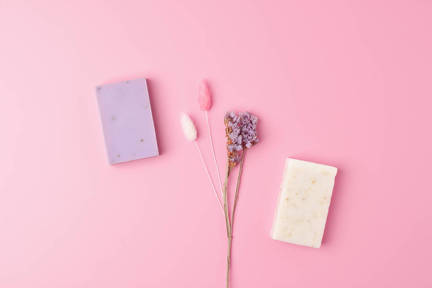 Soap with flowers on pink background. Flat lay, copy space. - Photo, Image