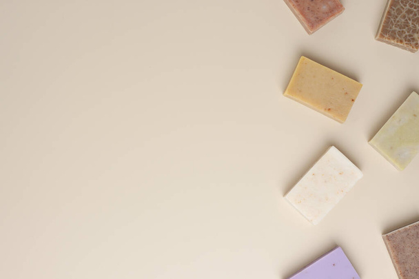 Soap on beige background. Flat lay, copy space. - Photo, image