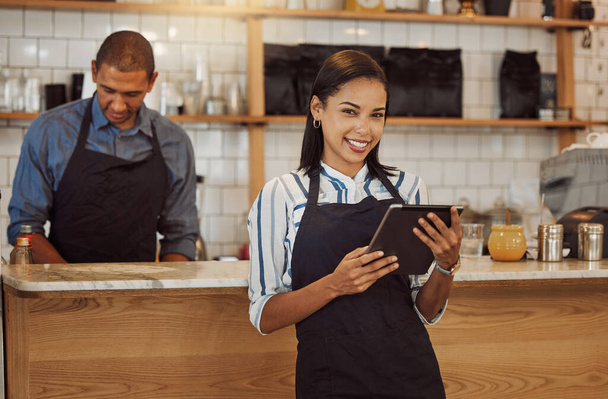 Portrait of a businesswoman ordering stock on her digital tablet. Business partners working together in restaurant kitchen. Entrepreneur using a wireless online device to order stock. - Φωτογραφία, εικόνα