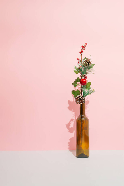Composição de férias de inverno mínima com um ramo decorativo em uma garrafa. Conceito de Natal e Ano Novo. - Foto, Imagem
