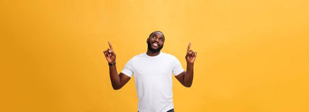 Young african american man over yellow background pointing upwards. - Photo, Image