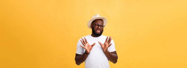 Closeup portrait of shocked mad young man raising hand up to say no stop right there, isolated on yellow background. Negative emotion facial expression feelings, signs symbols, body language - Photo, Image
