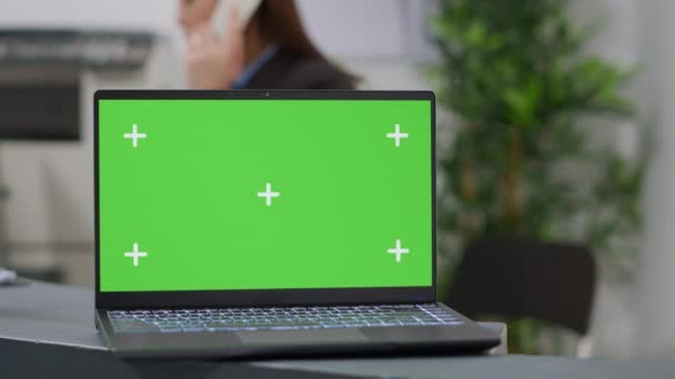 Laptop with greenscreen template at hospital reception desk used by medical staff. Using mockup background with isolated chroma key display and blank copyspace on monitor screen. Close up. - Filmati, video