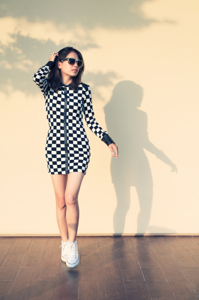 jovem e bela mulher hipster contra a luz e sombra em wa
 - Foto, Imagem