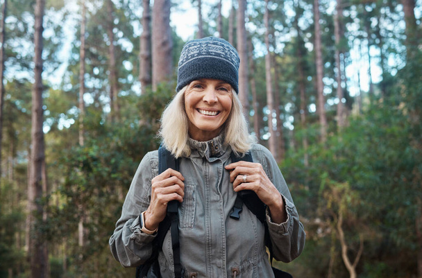 Hiking brings me contentment. a mature woman wearing her backpack while out hiking - Fotoğraf, Görsel