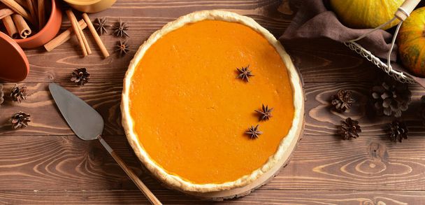Tasty pumpkin pie on wooden table. Thanksgiving Day celebration - Photo, Image