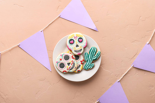 Plate with cookies and flags on beige background. El Dia de Muertos - 写真・画像