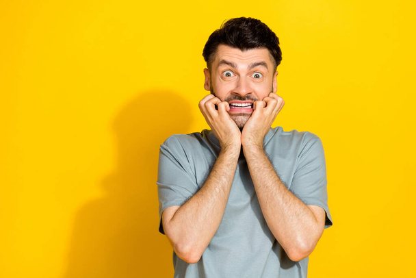 Closeup photo of young nervous man bite fingers problems deadline work manager crazy unexpected empty space isolated on yellow color background. - Valokuva, kuva