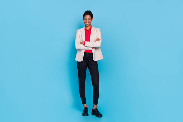 Full size portrait of successful person crossed arms wear blazer trousers isolated on blue color background. - Фото, изображение