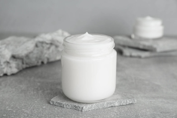 Jar of hand cream on gray marble table - Foto, afbeelding
