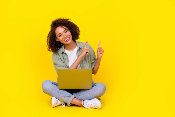 Full size photo of cute young woman wavy hair use netbook it specialist coder wear stylish khaki shirt isolated on yellow color background. - Φωτογραφία, εικόνα
