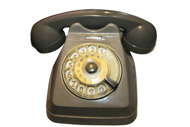 Eski ve kullanılmış bir fildişi ve altın renkli ev telefonu. Eski günlerin beyaz arka plandaki iletişimini hatırlamak için bir nesne. - Fotoğraf, Görsel
