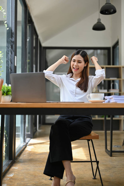 Portrait, Overjoyed and cheerful young Asian businesswoman or female office employee showing triumphs, celebrating her success, victory, winning, new job offer, job promotion. - Photo, Image