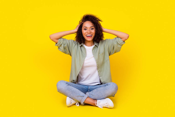 Full body photo of winsome young lady curly hair impressed good news win lottery wear trendy khaki look isolated on yellow color background. - Photo, Image