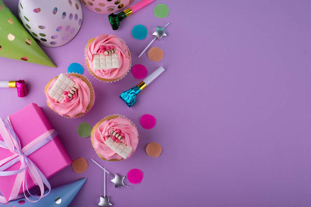 Birthday partry concept with cupcake, confetti and garland - Photo, Image