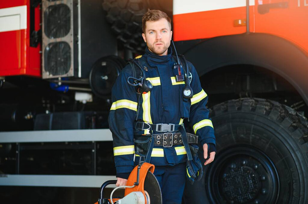 Photo of fireman with gas mask and helmet near fire engine. - Fotoğraf, Görsel
