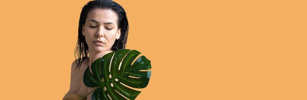 Beauty Woman with natural green palm leaf portrait. Fashion, beauty, make-up, cosmetics. - 写真・画像