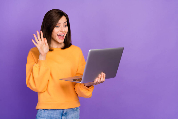 Photo of young attractive gorgeous nice lady wear stylish outfit hold computer excited speak online blog youtube blog hello isolated on purple color background. - Foto, afbeelding