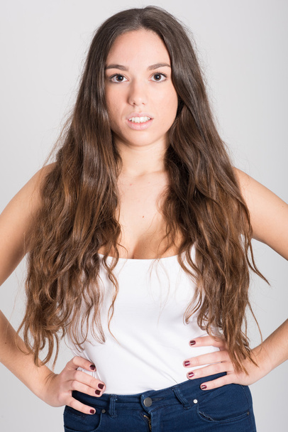 Woman with long hair wearing white t-shirt and blue jeans - Fotoğraf, Görsel