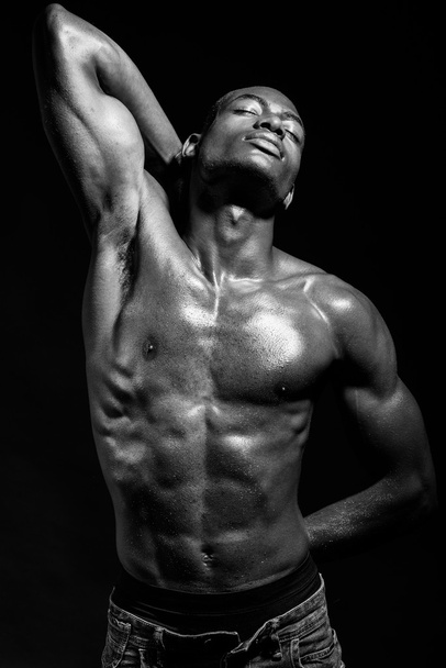 Athletic black man on black background - Фото, зображення