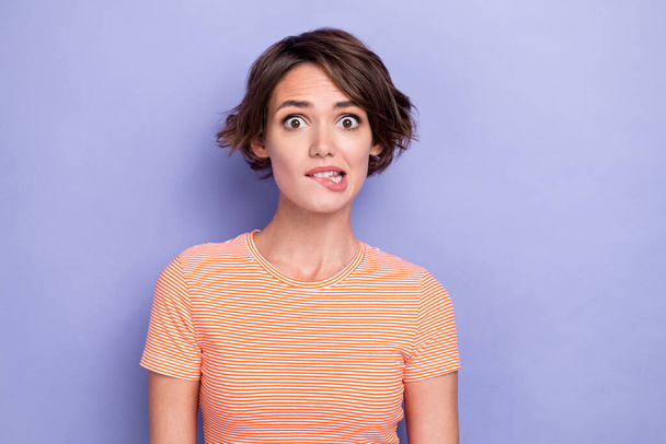 Closeup photo of young pretty nice cute gorgeous woman bob hair nervous stressed worker deadline manager bite lips isolated on purple color background. - Foto, Imagem