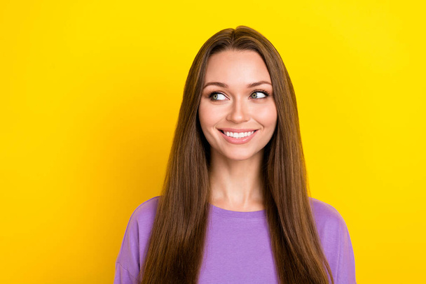Closeup photo of cute positive adorable woman brown long hair toothy beaming smile looking empty space interested news isolated on yellow color background. - Foto, imagen