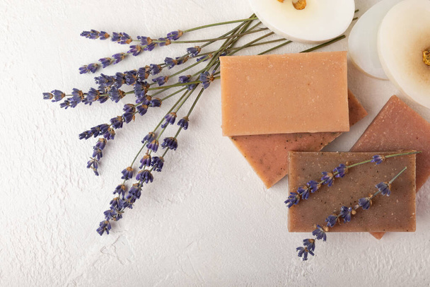Natural soap with lavender extract. Handmade soap with lavender flowers on a white texture background. spa and relaxation concept.Aromatherapy.Flat lay.Place for text.Place for copy. - Zdjęcie, obraz