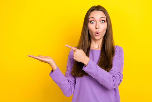 Photo of funny excited shocked businesswoman hold her palm unexpected reaction finger pointing empty space promo pouted lips isolated on yellow color background. - Foto, Imagem