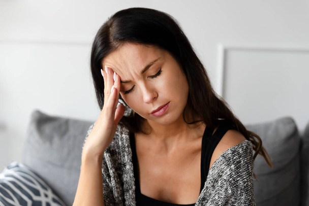 Woman has a headache, sadness and depression concept - Foto, imagen