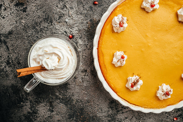 Homemade pastry for Thanksgiving traditional Pumpkin Pie with whipped cream. Long banner format. top view. - Foto, afbeelding