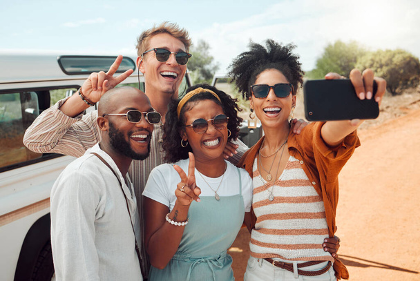 Diversity, selfie and friends on road trip adventure in a countryside taking a picture on phone. Travel, holiday and group of people with smartphone, car and smile on faces, happy on nature vacation. - Photo, Image