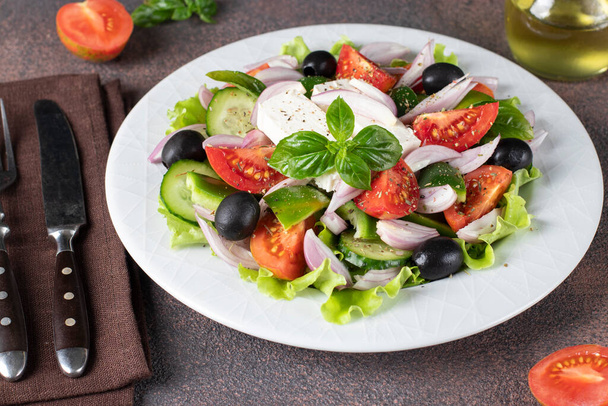 Klasik Yunan salatası. Domates, salatalık, tatlı biber, zeytin, fesleğen ve beyaz tabakta beyaz peynir. - Fotoğraf, Görsel