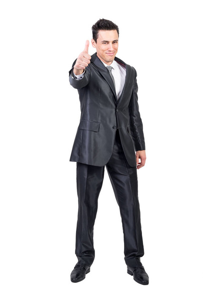 Full length of delighted male entrepreneur in classy suit showing thumb up and expressing approval while looking at camera on white background - Fotografie, Obrázek