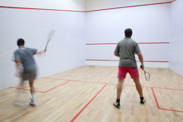 Squash players in action on a squash court (motion blurred image - 写真・画像