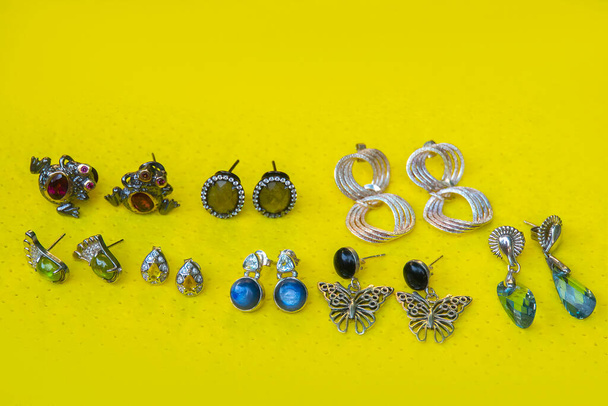 Sterling silver earrings on yellow background - Foto, Bild