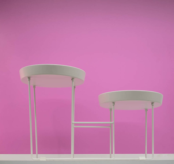 White stool isolated on pink background. Furniture for home. Nobody, selective focus, copy space for text - Photo, Image