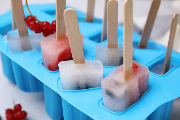 Mold with fruit and berry ice pops, closeup - 写真・画像