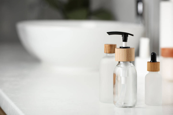 Different personal care products on countertop in bathroom. Space for text - Fotoğraf, Görsel