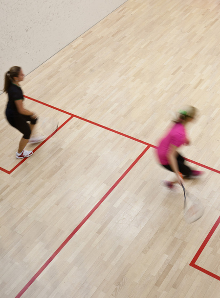 Two female squash players in fast action on a squash court (moti - Фото, изображение