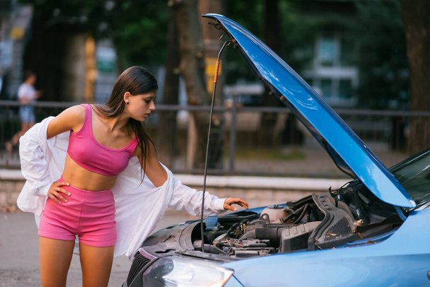 Žena s rozbitým autem na silnici se cítí vážně a ve stresu. Hledejte pomoc.. - Fotografie, Obrázek