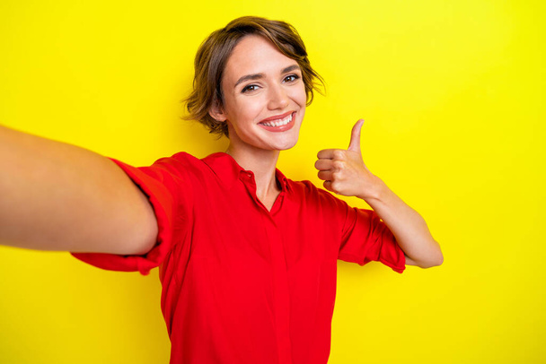 Portrait of adorable gorgeous girl with bob hairstyle wear red shirt doing selfie showing like isolated on yellow color background. - Φωτογραφία, εικόνα