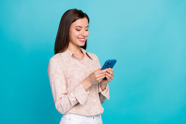 Photo of successful positive pretty business lady wear stylish pink shirt office worker manager chatting her boyfriend remote isolated on blue color background. - Photo, Image
