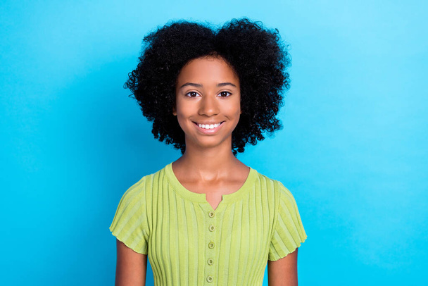 Portrait of satisfied optimistic positive girl with wavy hairstyle wear green t-shirt toothy smiling isolated on blue color background. - Foto, imagen