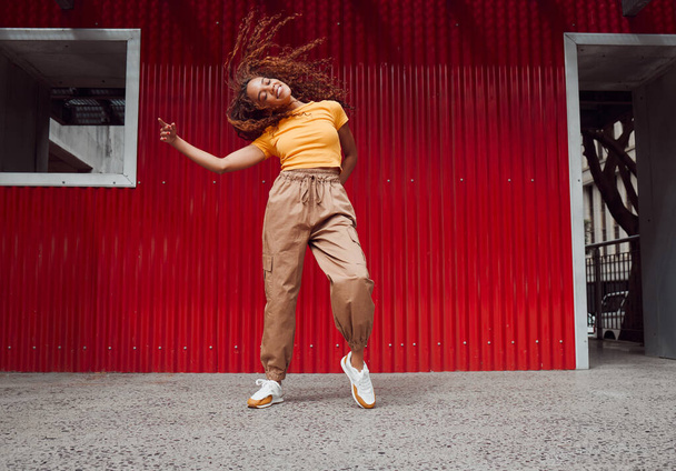 City, hip hop dance and an urban black woman in streetwear dancing outside in Sao Paulo. Music, dancer and a cool happy latino girl with outdoor street style, fun energy, freedom and youth in Brazil - 写真・画像